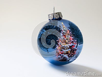 Shiny Blue Holiday Ornament Reflects Brightly Lit Colorful Christmas Tree Stock Photo