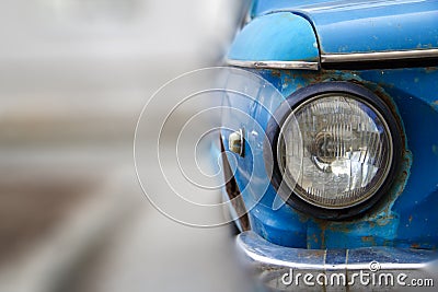 Shiny blue vintage car. Detail view of the headlight. Retro car. Front light. Retro automobile scene. Circle headlamp Stock Photo