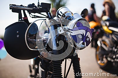 Shiny chrome caferacer motorcycle with helmet on steering bar Stock Photo