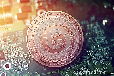 Shiny copper BYTECOIN cryptocurrency coin on blurry motherboard background Stock Photo