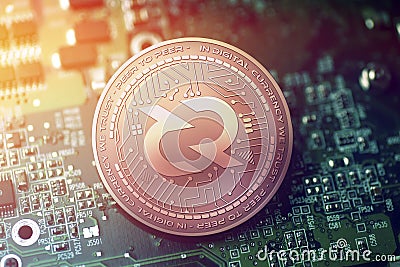 Shiny copper DECRED cryptocurrency coin on blurry motherboard background Stock Photo