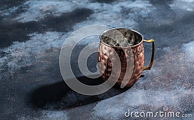 Shiny copper Moscow Mule mug with handle. Hammered Vintage Copper Mug Stock Photo