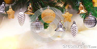Shiny gold and silver christmas balls, stars and bells on white with pine tree for new year Stock Photo