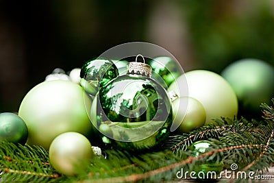 Shiny green christmas baubles closeup macro and tree Stock Photo