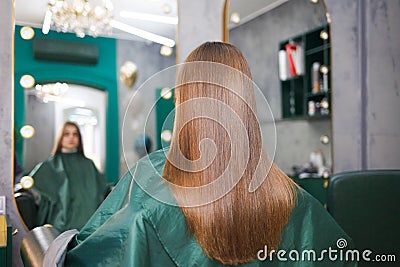 Shiny and straight hair of a young girl after a hair lamination procedure. Keratine and botox hair Stock Photo