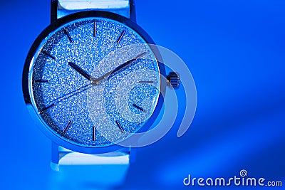 Shiny Luxury watch on blue background Stock Photo