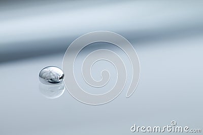 Shiny Mercury drops on a grey background Stock Photo