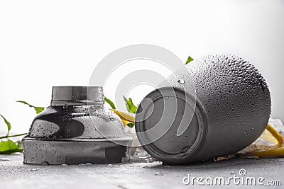 Shiny metal cocktail shaker on a gray background. Opened gray container on a gray table. A jar for making cocktails. Stock Photo