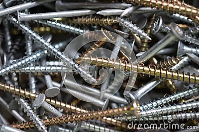 A jumble of nails and screws. Construction hardware background Stock Photo
