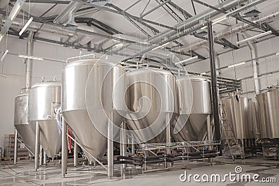 Shiny microbrewery beer tanks at beer factory Stock Photo