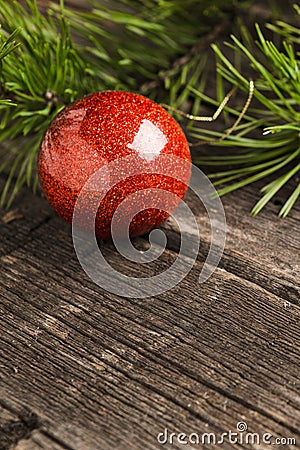 Shiny red christmass ball with green fir pine branch Stock Photo