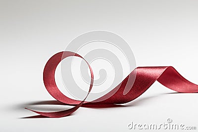 Shiny silk wavy burgundy ribbon on Stock Photo