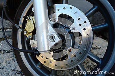 Shiny steel front brake disc detail on scooter or motorcycle Stock Photo