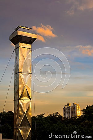 Steel smokestack and cloud in twilight sparkle Stock Photo