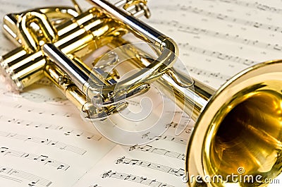 Shiny trumpet on sheet music Stock Photo