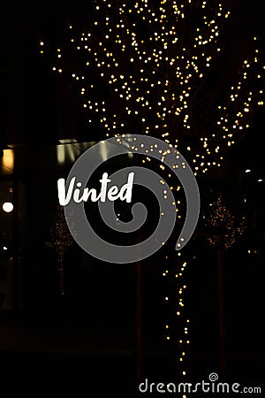 Shiny Vinted logo sign at night. Editorial Stock Photo