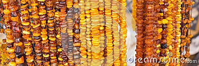 Shiny womanly amber necklaces on stall at the bazaar Stock Photo