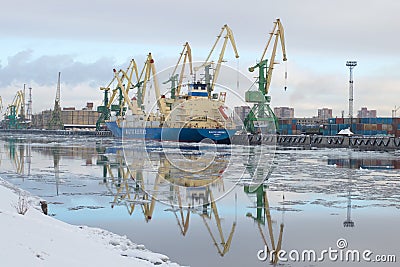 The ship Baltic spring is unloaded at the cargo port, february morning. The Gunboat canal, Saint Petersburg Editorial Stock Photo