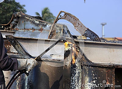 Ship Breaker Gas Cutter demolishing part of INS Vikrant in Darukhana Ship Breaking Yard (close up) Stock Photo