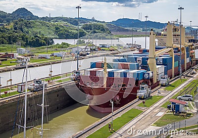 Ship crossing Panama Canal being lowered at Miraflores Locks - Panama City, Panama Editorial Stock Photo