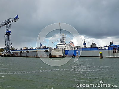 Ship is in dock at warf to be maintenained in the Waalhaven harbor at Damen in port of Rotterdam. Editorial Stock Photo