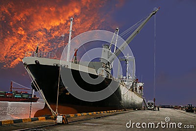 Ship loading goods at quay wall Stock Photo