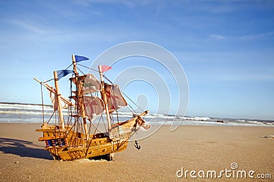 Ship model on summer sunny beach Stock Photo