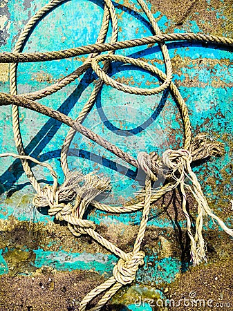 Ship ropes and blue wooden background of boat bottom. Art abstraction for poster. Stock Photo