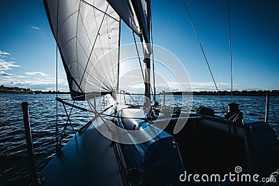 Ship ropes and sails, yacht nose on a sunset on a river Stock Photo