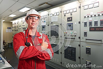 Ship`s mechanic near marine diesel generators on a merchant ship in the engine room Stock Photo