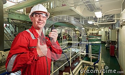 Ship`s mechanic near marine diesel generators on a merchant ship in the engine room Stock Photo