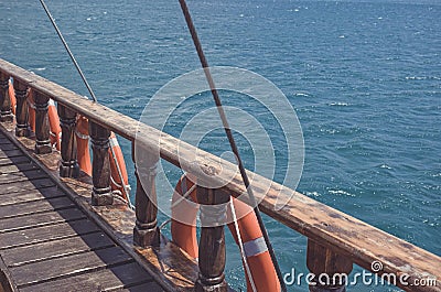 Ship`s old wooden side with lifebuoys Stock Photo