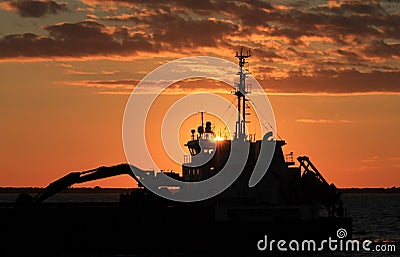 Ship on sea at sunset. Stock Photo