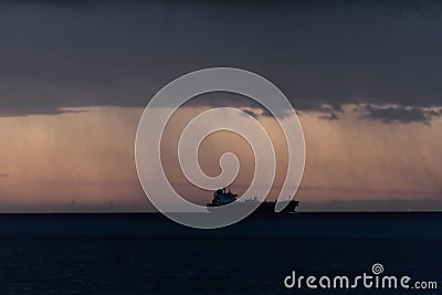 A ship is seen cruising under a storm Stock Photo