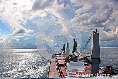 Ship structures, masts, antennas, funnel, ship wheelhouse against the blue sky and clouds. Stock Photo