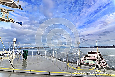 Ship structures, masts, antennas, funnel, ship wheelhouse against the blue sky and clouds. Stock Photo