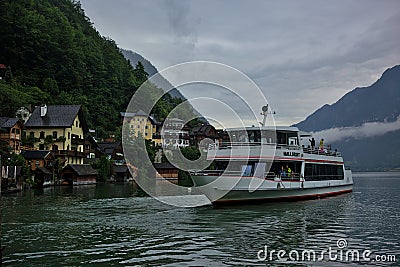 A ship with tourists on the picturesque Lake Hallstatter near the village of Hallstatt Editorial Stock Photo