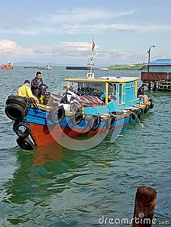 This is a ship transporting people and motorcycles, from Balikpapan City to Penajam, Indonesia. Editorial Stock Photo