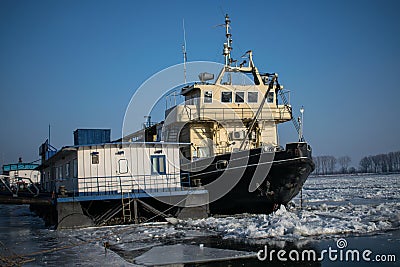 Ship trapped in ice on frozen Danube river from Romania Stock Photo