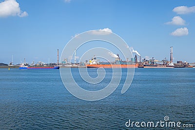 Ship unloads iron ore at the steel mill on the coast near IJmuiden, the Netherlands. Editorial Stock Photo