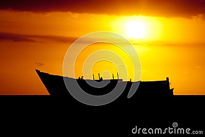 Ship wreck silhouette at sunset Stock Photo
