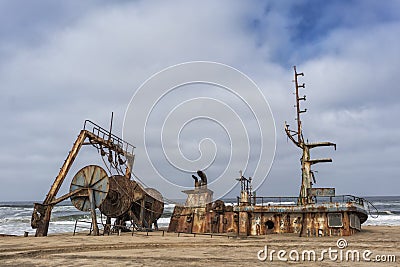 Ship wrecked and buried and abandoned on the coast of the Namibe Desert. Africa, Angola. Stock Photo