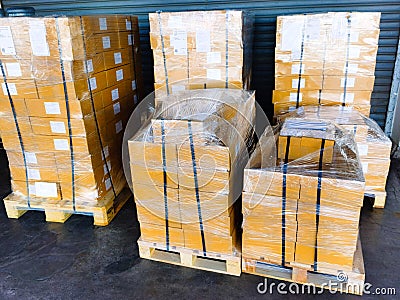 Shipment cartons box on pallets and wooden case on hand lift in interior warehouse cargo for export and sorting goods in freight Stock Photo