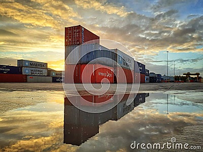 shipping container boxes on a port at sunset Editorial Stock Photo