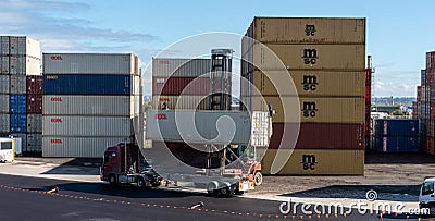 Shipping container storage yard a forklift putting a container on a truck in sydney 05-16-2020 australia Editorial Stock Photo