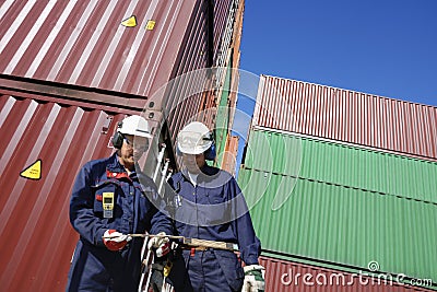 Shipping containers and dock workers Stock Photo