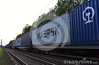 Shipping containers of `MAERSK SHIPPING` transport on cargo train by railway. China-Europe freight trains. Object in motion, sof Editorial Stock Photo