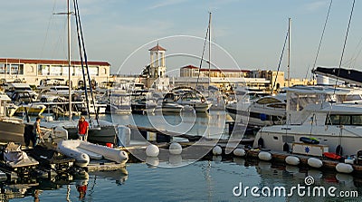 Ships, yachts and boats on blue surface of Black Sea by pier of Commercial seaport of Sochi. Resort city center. Sochi Editorial Stock Photo