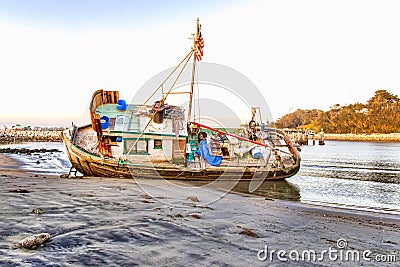 Shipwreck Awash on Beach Stock Photo