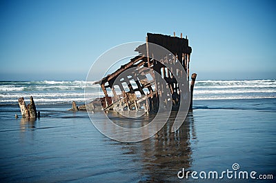 Shipwreck in Ocean Waves Stock Photo